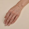 Dainty gold bracelet with square-cut sapphire - delicate luxury on woman's wrist