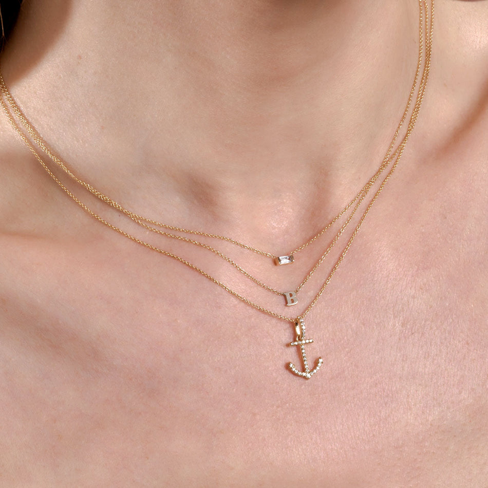 Influencer wearing a stack of personalized necklaces.
